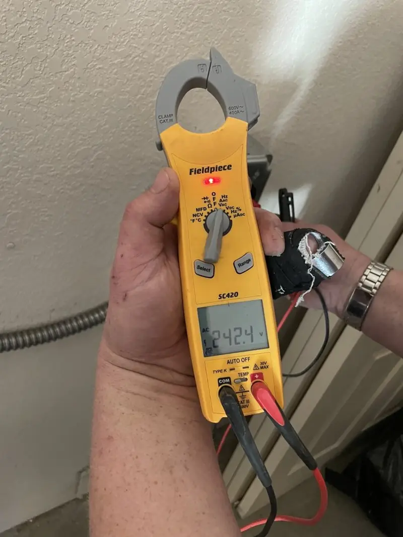 Voltage testing with clamp meter during Outlet Installation in Sunland Park
